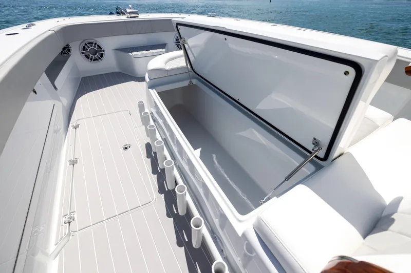 Slide: The Image of 2024 Freeman 43 boat interior with open storage compartment and rod holders. - 62