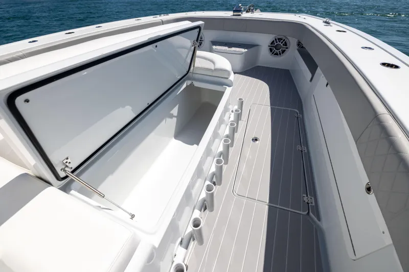 Slide: The Image of 2024 Freeman 43 boat interior with open storage compartment and rod holders. - 64