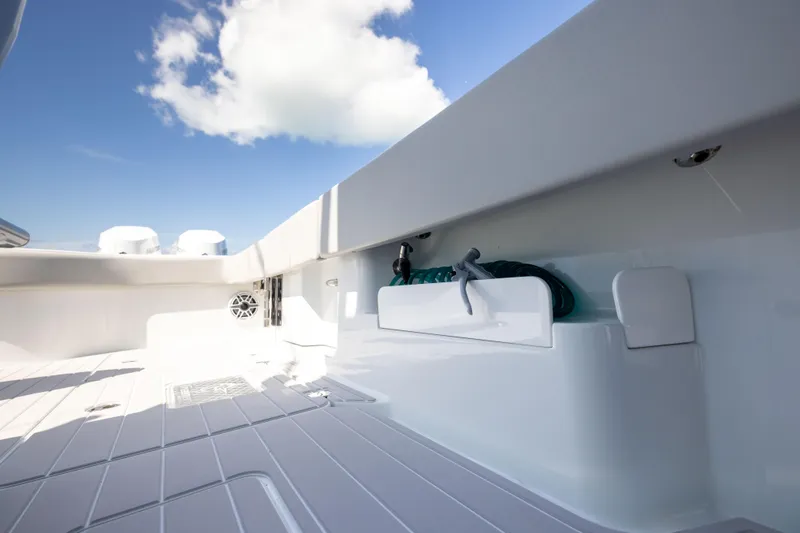 Slide: The Image of 2024 Freeman 43 boat deck with storage compartment under a clear blue sky. - 67