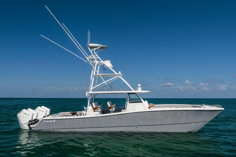 Slide: The Image of 2024 Freeman 43 boat on open water under clear blue sky. - 8