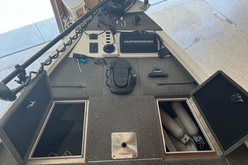 Slide: The Image of 2016 Lund 1875 Pro-V Bass XS boat interior with Humminbird electronics and storage compartments. - 8