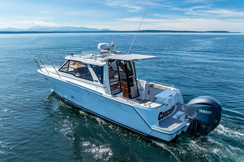 Slide: The Image of 2024 Cutwater C-248 Coupe boat cruising on open water with Yamaha engine. - 13