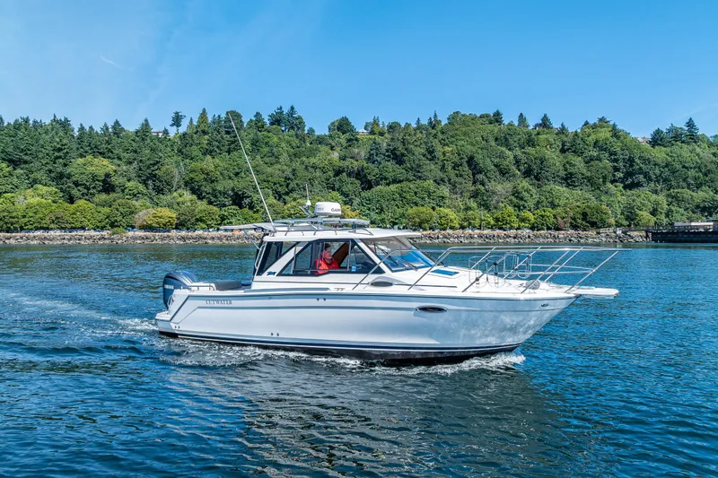 Slide: The Image of 2024 Cutwater C-248 Coupe boat cruising on open water, rear deck view. - 16