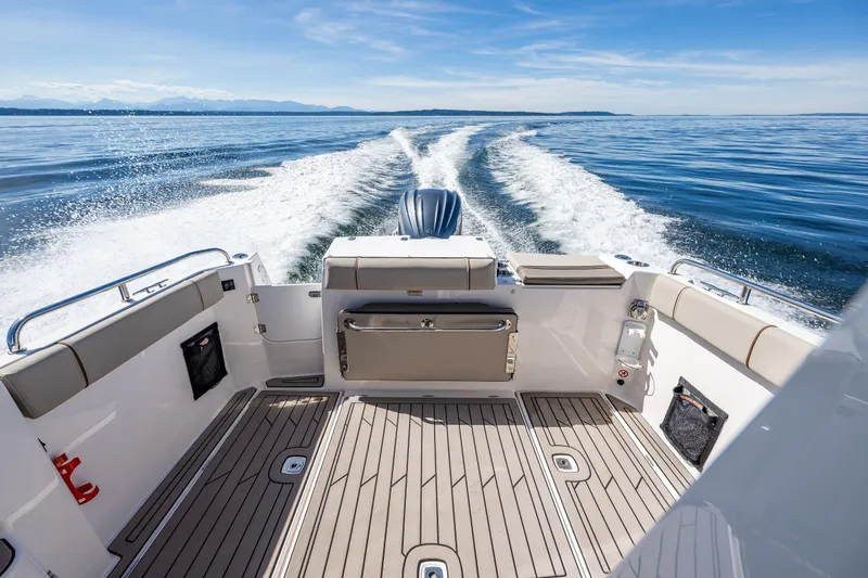 Slide: The Image of 2024 Cutwater C-248 Coupe interior view, showcasing seating and helm on a sunny day. - 17