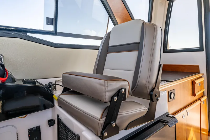 Slide: The Image of 2024 Cutwater C-248 Coupe interior with dining area, helm, and cabin view. - 27