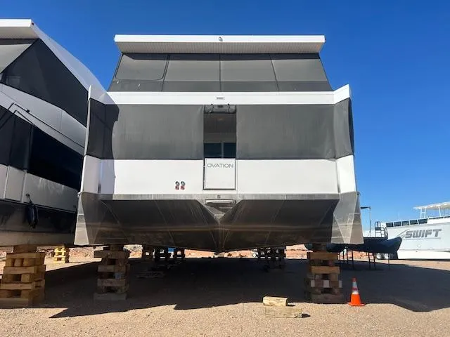 Slide: The Image of 2023 Adonia Ovation Shared Ownership Trip 5 houseboat on blocks, under clear blue sky. - 4