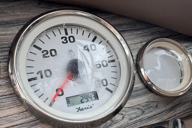 Slide: The Image of Speedometer of a 2015 Stingray 215 LR boat, displaying 294.7 hours. - 14