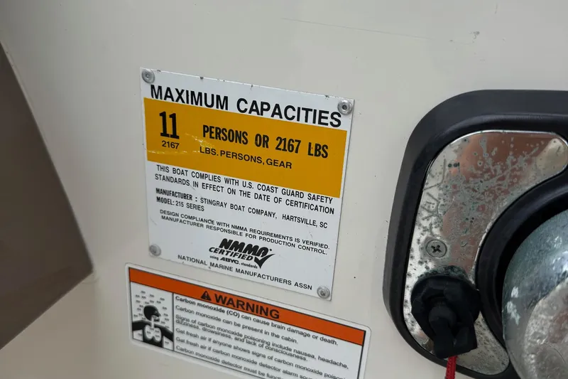 Slide: The Image of 2015 Stingray 215 LR boat capacity label, maximum 11 persons or 2167 lbs. - 15