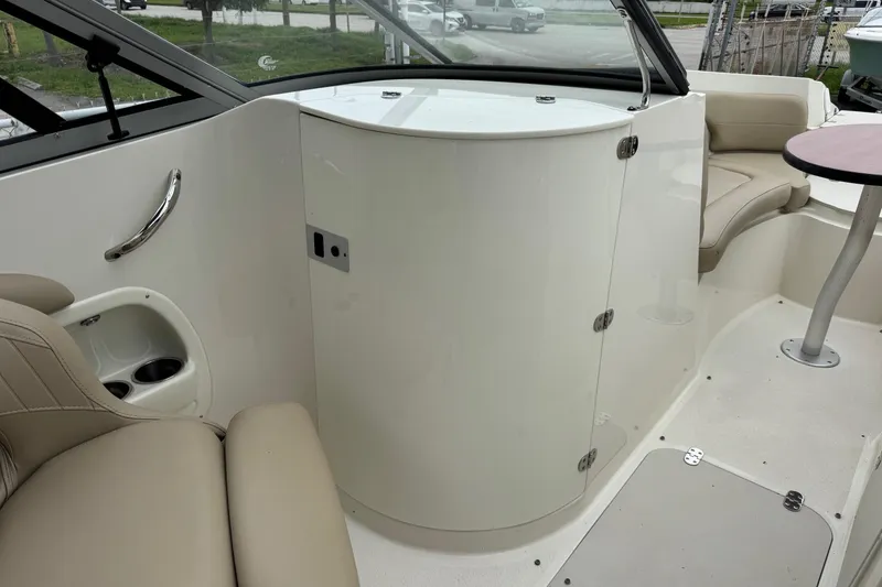 Slide: The Image of 2015 Stingray 215 LR boat interior with seating and storage compartment. - 19