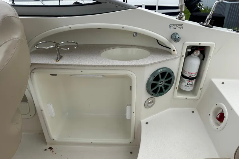 Slide: The Image of 2015 Stingray 215 LR boat interior with sink, speaker, and fire extinguisher. - 22