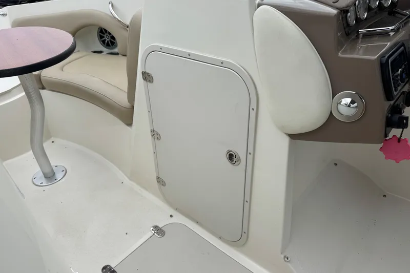 Slide: The Image of Interior of 2015 Stingray 215 LR boat with seating and control panel. - 23