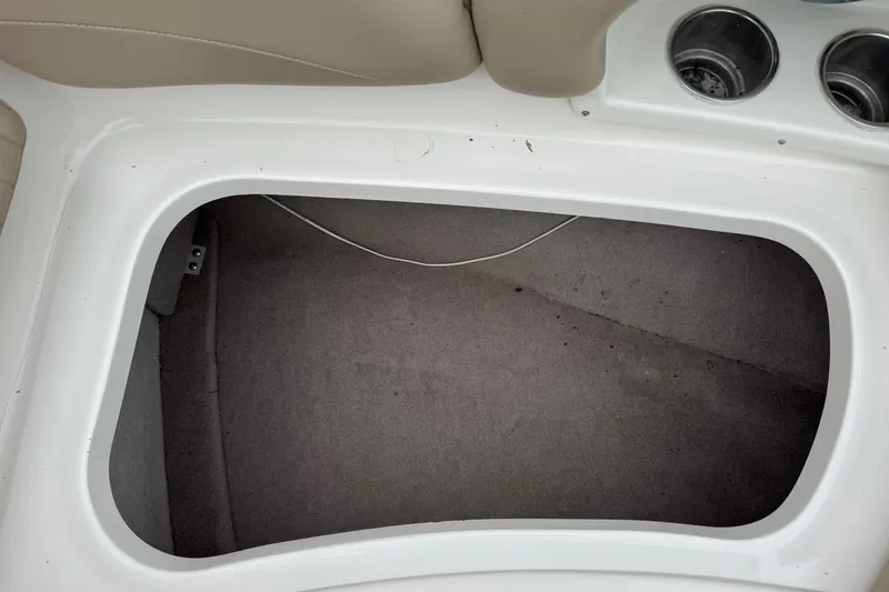 Slide: The Image of Open storage compartment in a 2015 Stingray 215 LR boat interior. - 28
