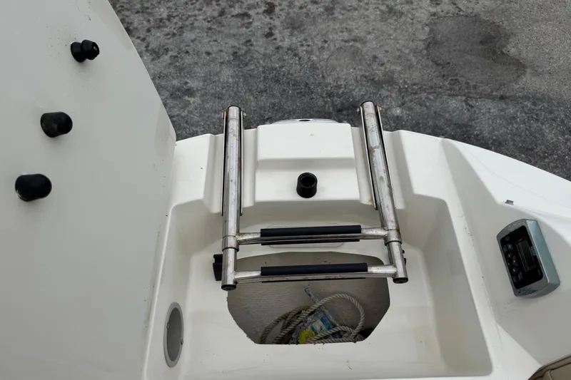 Slide: The Image of 2015 Stingray 215 LR boat ladder and storage compartment on deck. - 30