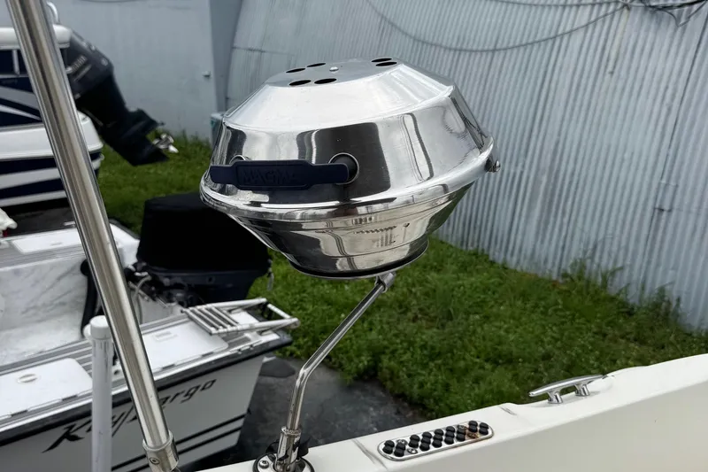 Slide: The Image of Stainless steel grill mounted on a 2015 Stingray 215 LR boat, near other vessels. - 33