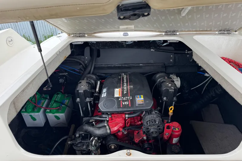 Slide: The Image of Engine compartment of a 2015 Stingray 215 LR boat, featuring a 225 V6 engine. - 34