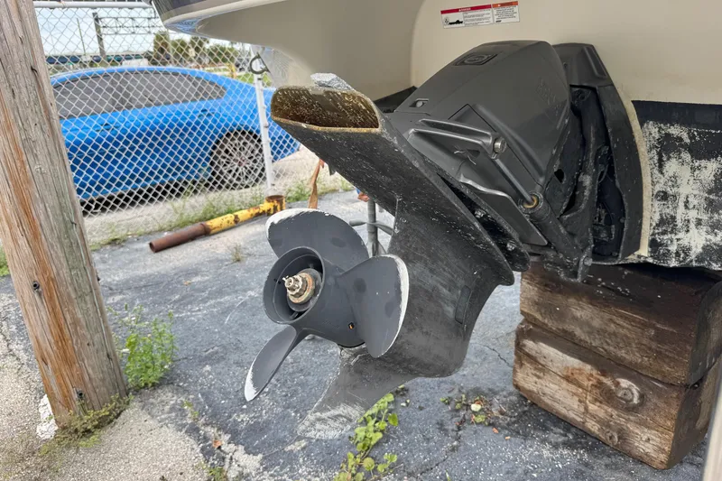 Slide: The Image of 2015 Stingray 215 LR boat propeller and outdrive on wooden blocks. - 38