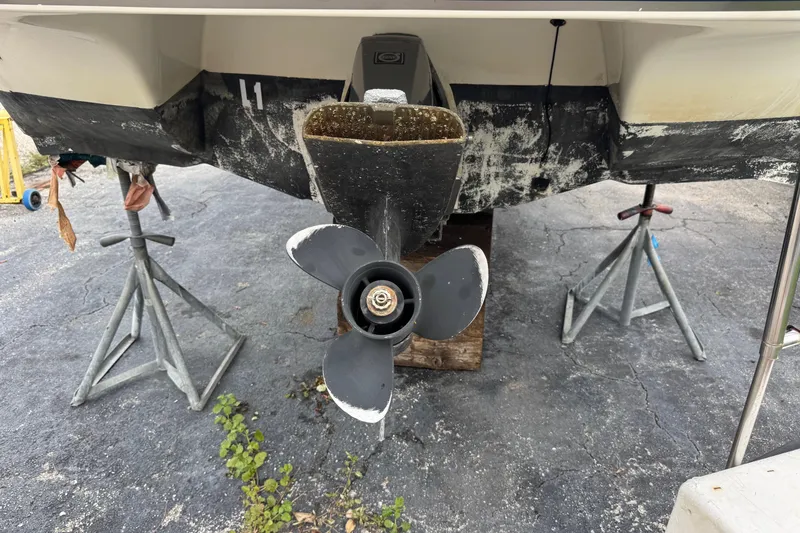 Slide: The Image of 2015 Stingray 215 LR boat propeller and stern on stands, showing wear and maintenance. - 39