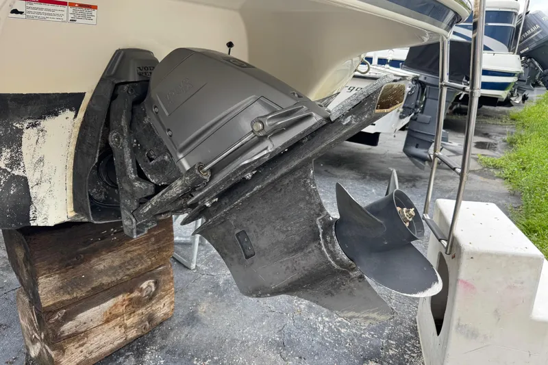 Slide: The Image of 2015 Stingray 215 LR boat with Volvo Penta outdrive, displayed on wooden blocks. - 40