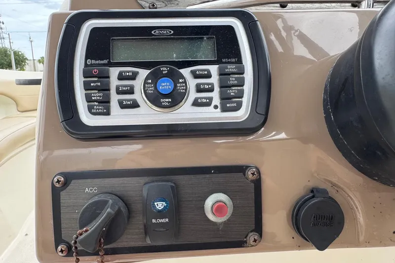 Slide: The Image of Control panel of a 2015 Stingray 215 LR boat featuring a Jensen audio system. - 9