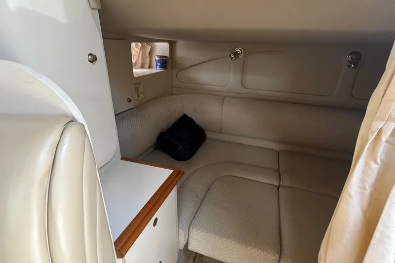 Slide: The Image of 2003 Cruisers Yachts 3372 Express interior with seating and table, docked at marina. - 13