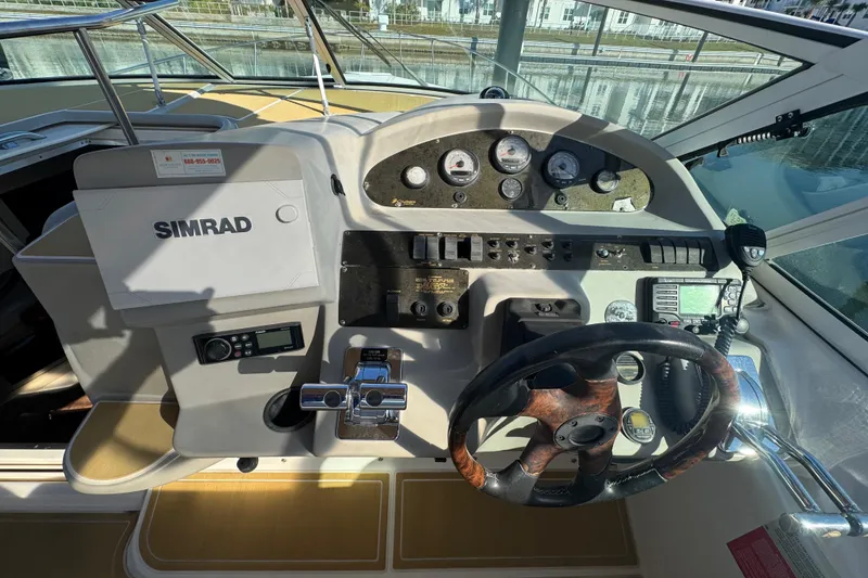 Slide: The Image of 2003 Cruisers Yachts 3372 Express helm with Simrad navigation system and steering wheel. - 14