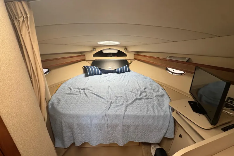 Slide: The Image of 2003 Cruisers Yachts 3372 Express interior with seating and table, dockside view. - 15