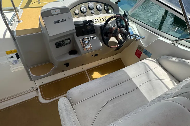 Slide: The Image of 2003 Cruisers Yachts 3372 Express on calm water, rear view with clear blue sky. - 5