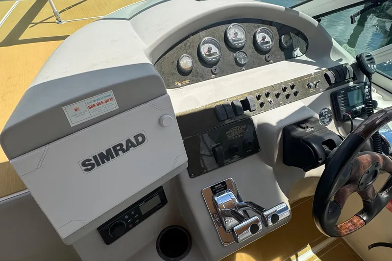 Slide: The Image of 2003 Cruisers Yachts 3372 Express interior with seating and table, docked at marina. - 9