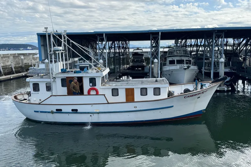The Image of 1983 Custom Entienne Francois 50 Pilothouse boat docked at marina under cloudy sky. - 0