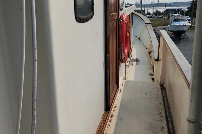 Slide: The Image of Side view of 1983 Custom Entienne Francois 50 Pilothouse boat with red life preserver. - 14