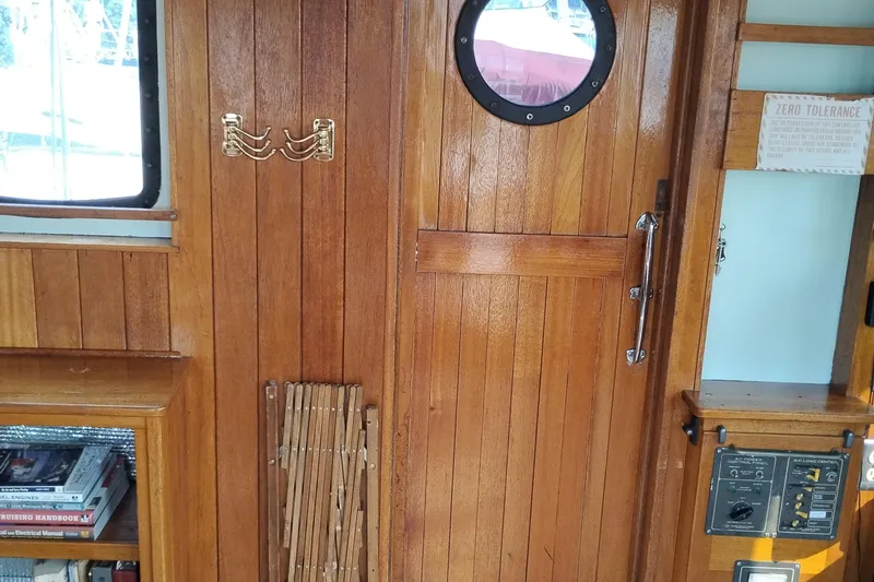 Slide: The Image of Interior of 1983 Custom Entienne Francois 50 Pilothouse with wooden paneling and nautical decor. - 17