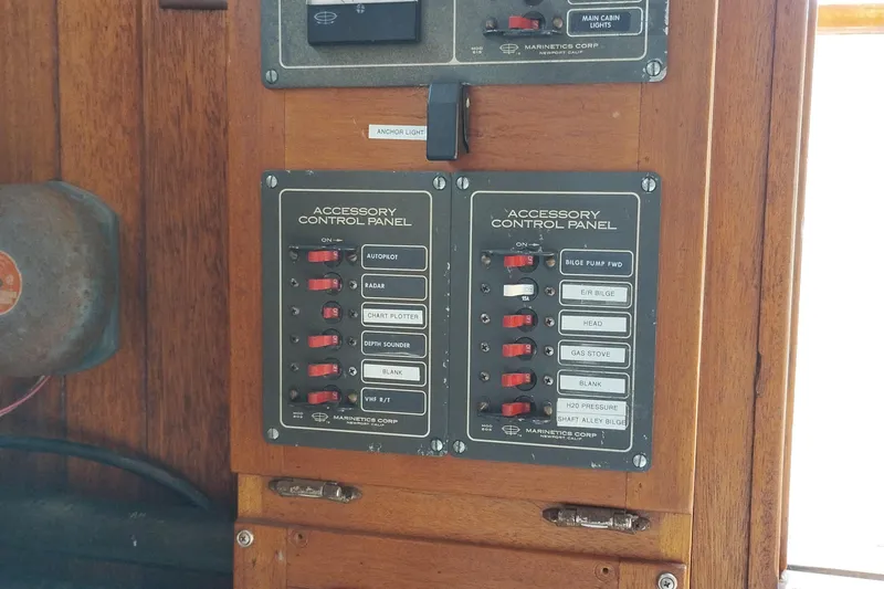 Slide: The Image of Control panel on 1983 Custom Entienne Francois 50 Pilothouse boat, featuring various switches. - 22