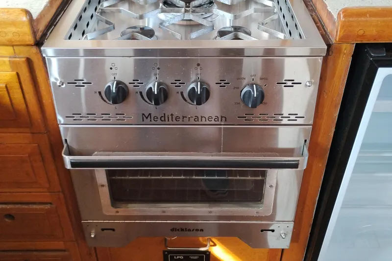Slide: The Image of Stainless steel Mediterranean stove and oven in a 1983 Custom Entienne Francois 50 Pilothouse. - 24