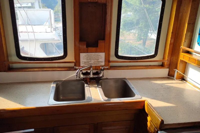 Slide: The Image of Interior of 1983 Custom Entienne Francois 50 Pilothouse with dual sinks and wooden accents. - 25