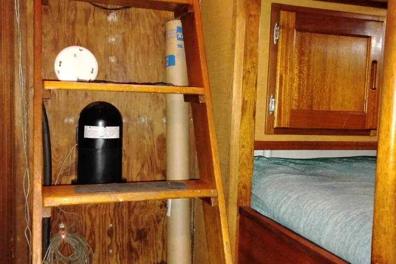 Slide: The Image of Interior of 1983 Custom Entienne Francois 50 Pilothouse with wooden shelves and bed. - 29