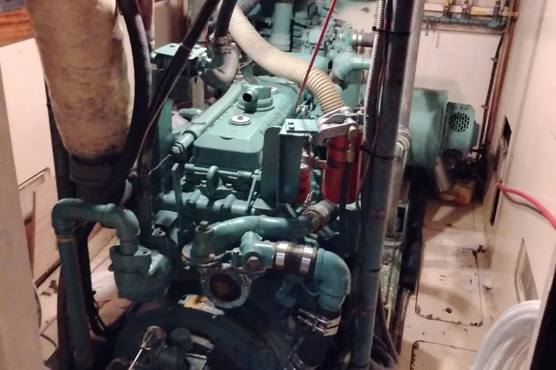 Slide: The Image of Engine room of 1983 Custom Entienne Francois 50 Pilothouse boat, showcasing machinery and pipes. - 36