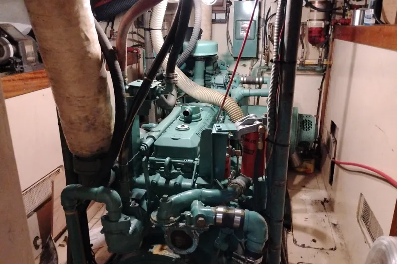 Slide: The Image of Engine room of 1983 Custom Entienne Francois 50 Pilothouse boat, showcasing machinery and pipes. - 37