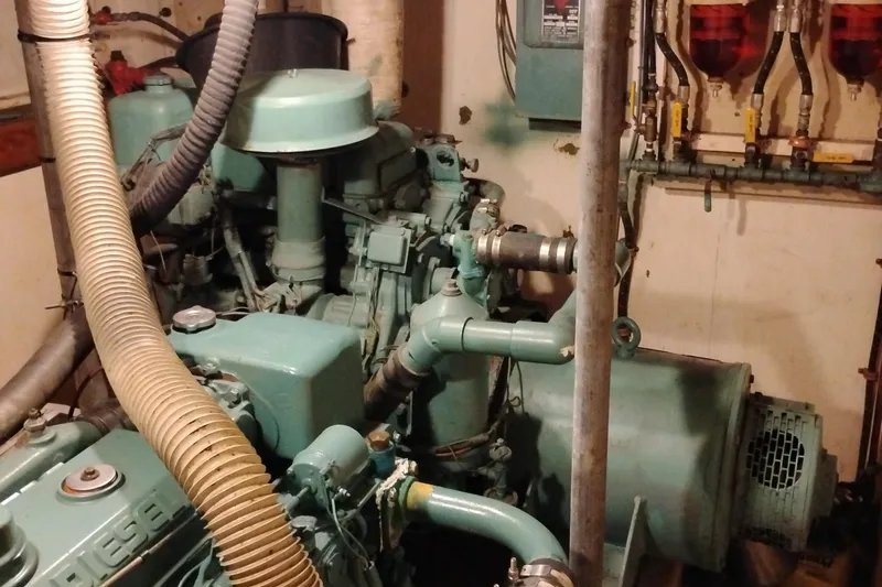 Slide: The Image of Engine room of 1983 Custom Entienne Francois 50 Pilothouse with visible machinery and pipes. - 38