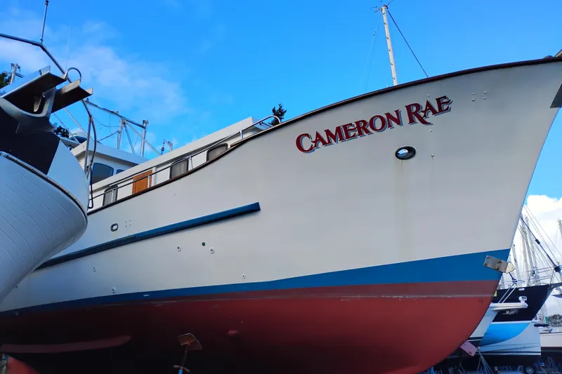 Slide: The Image of 1983 Custom Entienne Francois 50 Pilothouse boat named "Cameron Rae" docked under blue sky. - 45