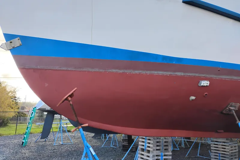 Slide: The Image of 1983 Custom Entienne Francois 50 Pilothouse boat hull on stands, red and blue paint. - 47