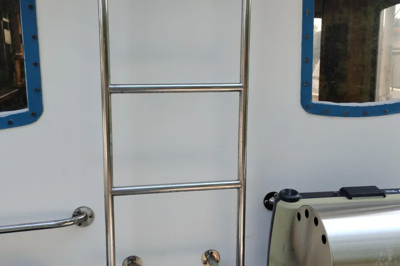 Slide: The Image of Stainless steel ladder on 1983 Custom Entienne Francois 50 Pilothouse boat exterior. - 5