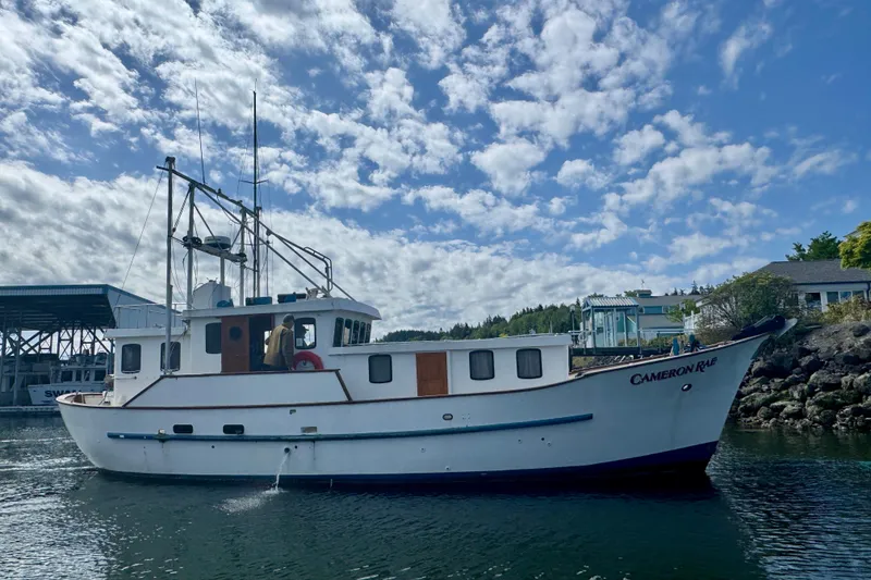 Slide: The Image of Custom Entienne Francois 50 Pilothouse boat from 1983 on calm water under a cloudy sky. - 52