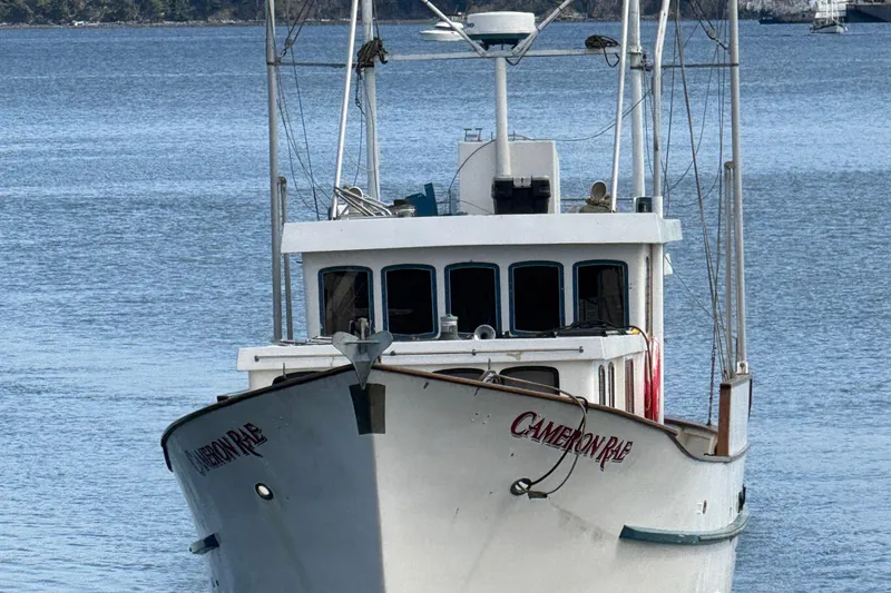 Slide: The Image of Front view of 1983 Custom Entienne Francois 50 Pilothouse boat on calm water. - 53