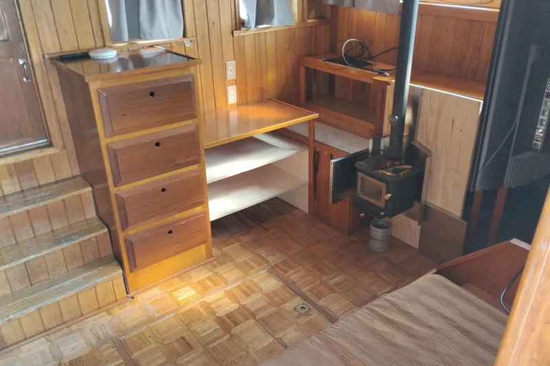 Slide: The Image of Interior of 1983 Custom Entienne Francois 50 Pilothouse with wood paneling and stove. - 7
