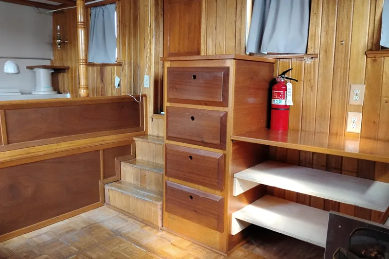 Slide: The Image of Interior of 1983 Custom Entienne Francois 50 Pilothouse with wood paneling and storage. - 9