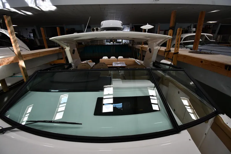 Slide: The Image of 2020 Sea Ray SLX 400 Outboard in indoor storage, showcasing sleek design and spacious interior. - 10