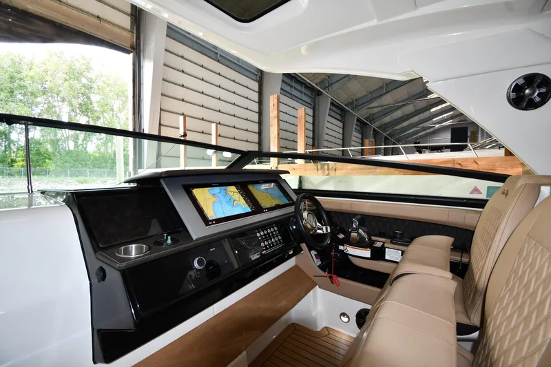 Slide: The Image of Interior of 2020 Sea Ray SLX 400 Outboard, featuring modern dashboard and luxurious seating. - 12