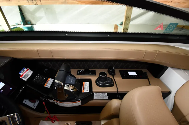 Slide: The Image of 2020 Sea Ray SLX 400 Outboard helm with modern controls and beige leather seating. - 13