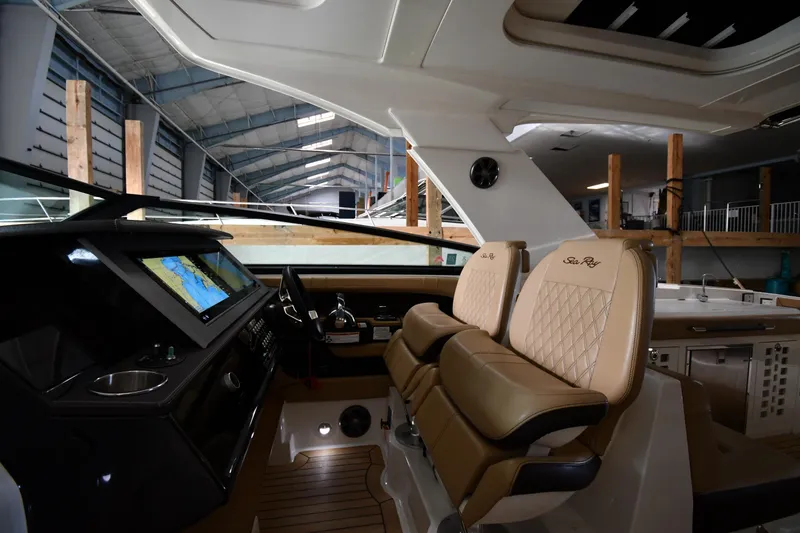 Slide: The Image of 2020 Sea Ray SLX 400 Outboard interior with luxurious seating and advanced navigation system. - 16
