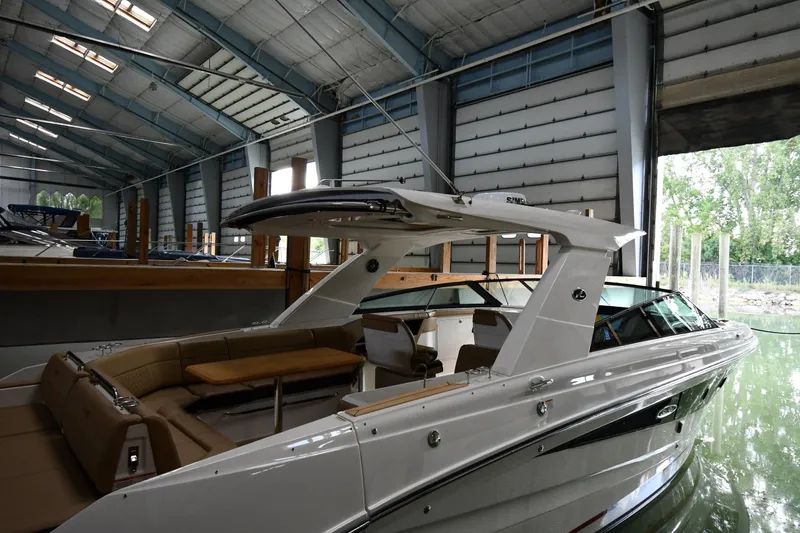 Slide: The Image of 2020 Sea Ray SLX 400 Outboard in a covered marina, showcasing sleek design and luxury features. - 2